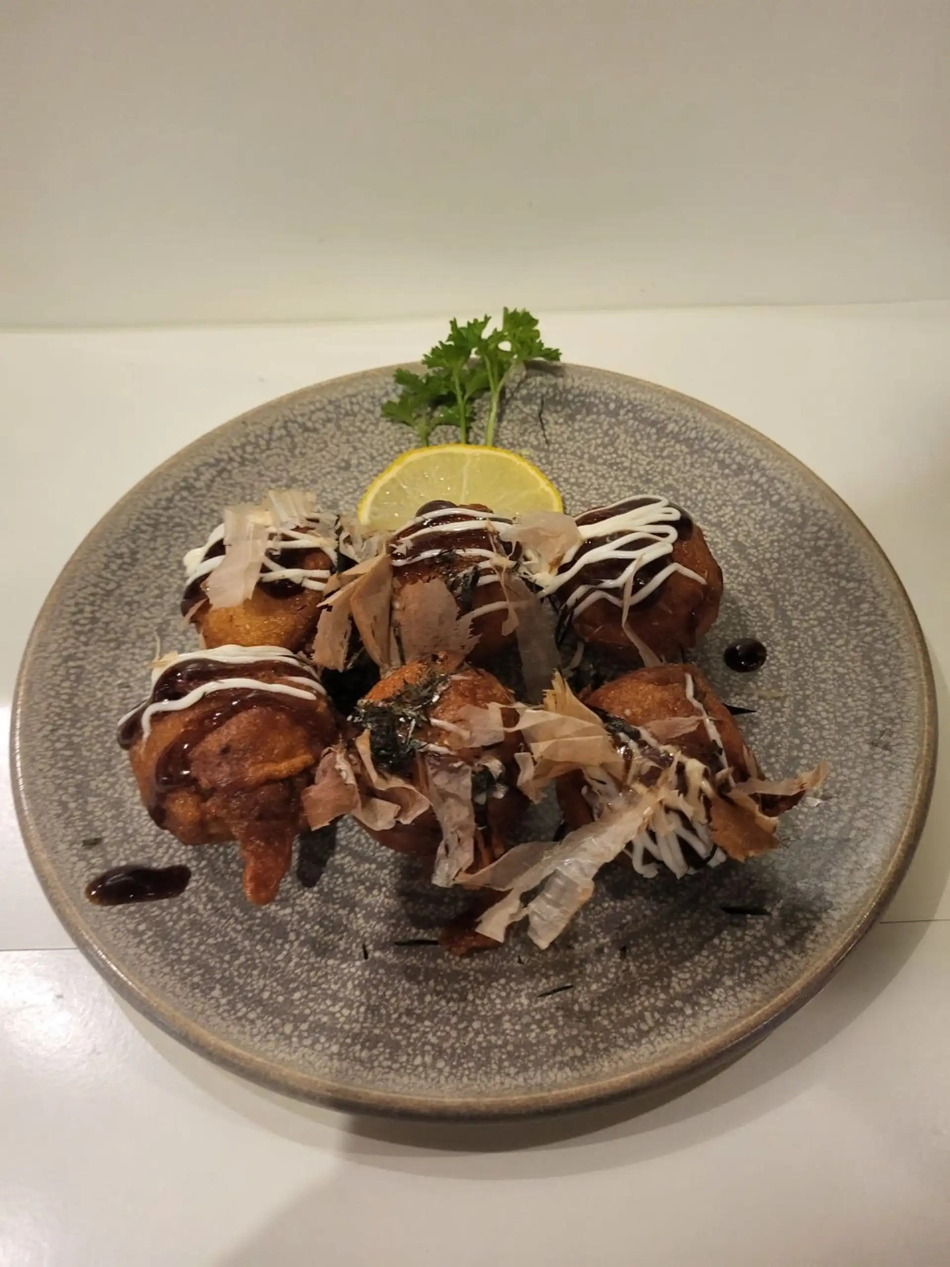 Takoyaki - Traditional Japanese octopus balls with takoyaki sauce, mayo, and bonito flakes